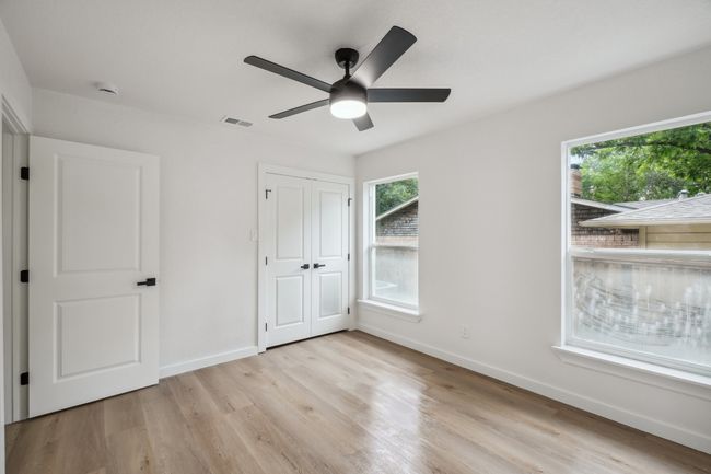 Unfurnished bedroom with baseboards, light wood-style flooring, a ceiling fan, and a closet | Image 29