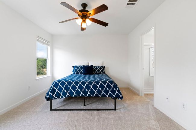 Tucked away for privacy, the spacious primary suite features a walk-in closet and an ensuite bathroom. | Image 6