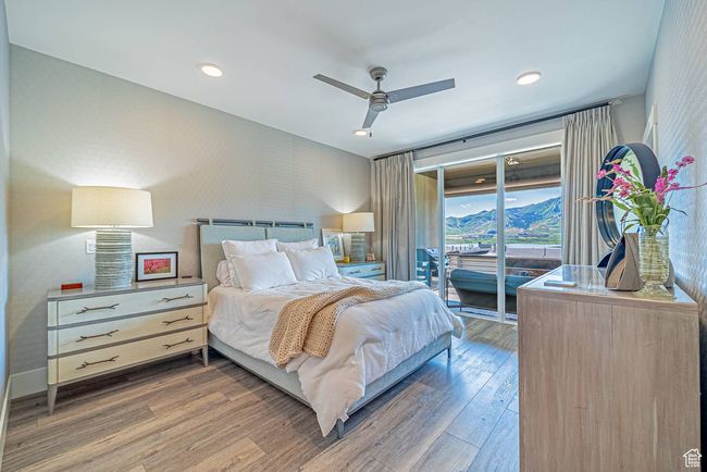 Primary Bedroom featuring access to outside, wood finished floors, ceiling fan, wallpapered walls, and baseboards | Image 5