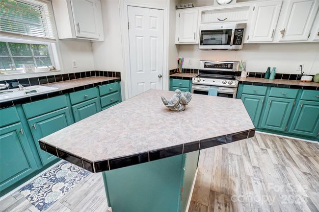 Ample cabinet and countertop space for storage and meal preparation. | Image 14