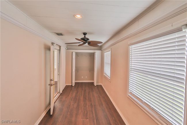 Hall with dark wood-type flooring, baseboards, and recessed lighting | Image 20