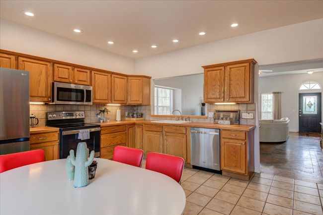 This kitchen has even more counter space and cabinets than shown in the photos! Plenty of prep space - and a door to the back deck for great indoor/outdoor entertaining! | Image 8