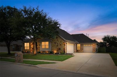 View of front of house with a garage and a lawn | Image 1