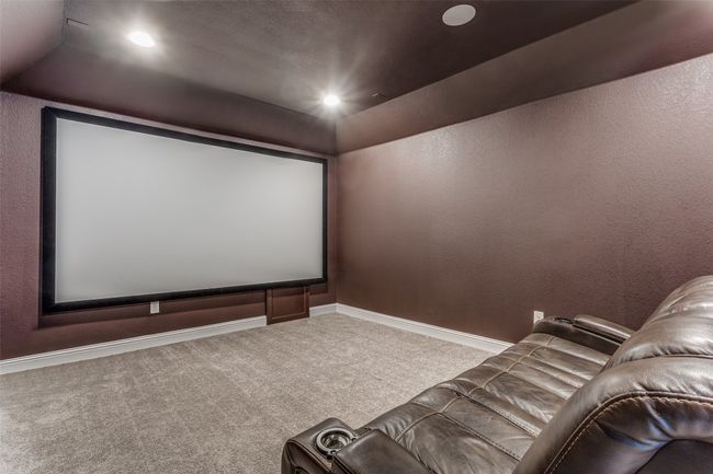 Cinema room featuring carpet, recessed lighting, vaulted ceiling, and a textured wall | Image 13