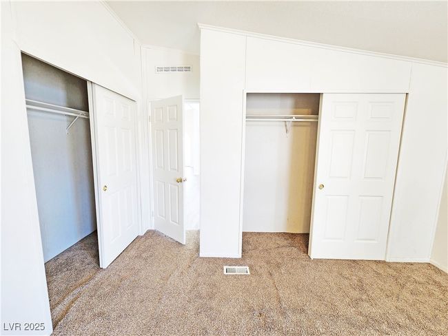Unfurnished bedroom featuring visible vents and carpet flooring | Image 23