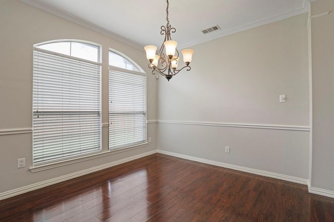 Unfurnished room featuring a chandelier, ornamental molding, and wood finished floors | Image 4