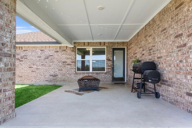 View of patio with a grill and an outdoor fire pit | Image 26