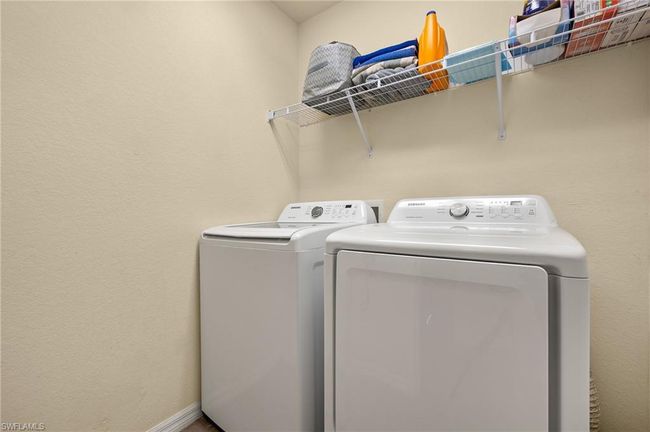 Laundry area featuring baseboards, washing machine and clothes dryer, and laundry area | Image 20