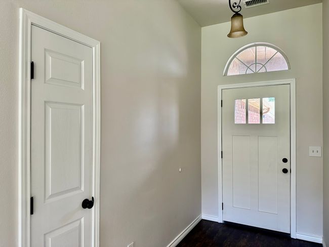 Entryway with dark wood-type flooring and baseboards | Image 20