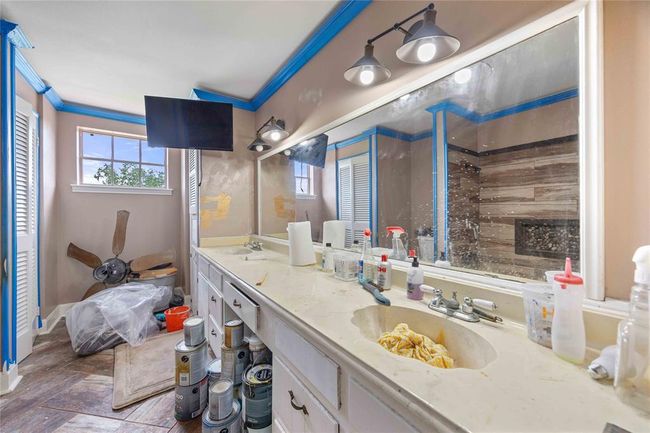 A view of the upstairs full bathroom with linen closet and double sink vanity. | Image 20