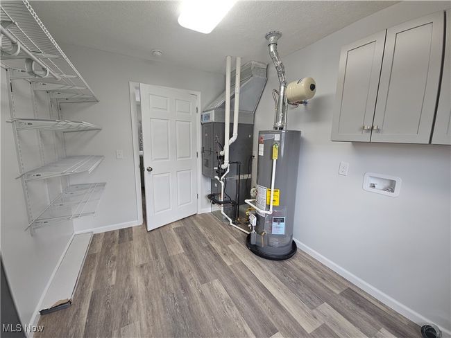 Storage cabinets over washer/electric dryer hookup. (Gas easily available) | Image 15