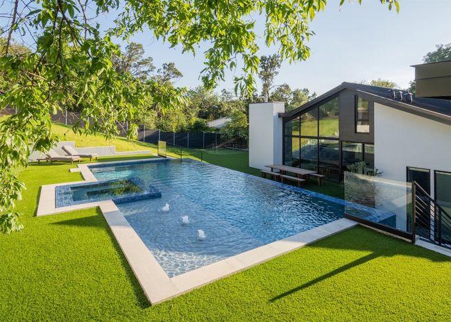 View of swimming pool with a pool with connected hot tub | Image 29