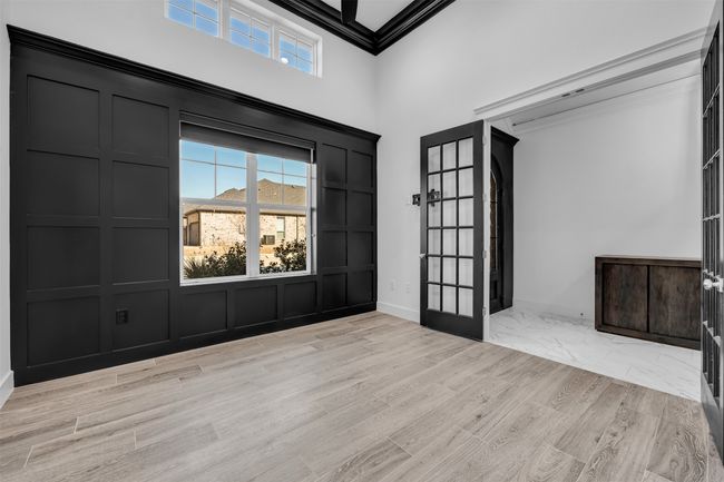 Foyer entrance featuring light wood finished floors, baseboards, ornamental molding, a high ceiling, and french doors | Image 11