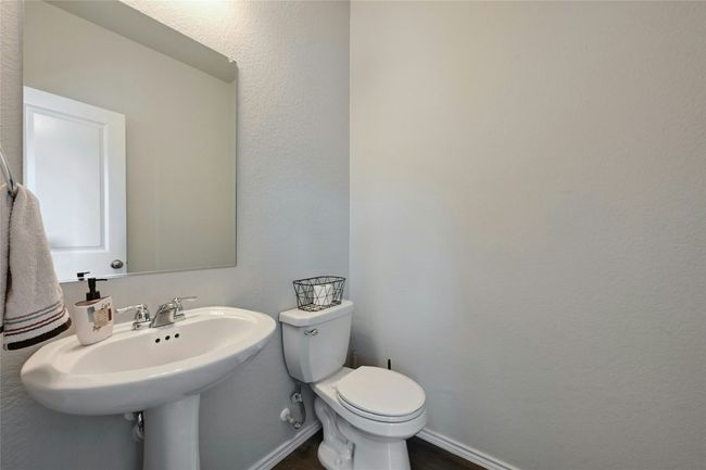 Bathroom featuring a textured wall and wood finished floors | Image 11