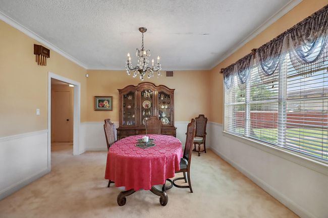 The formal dining sits at the back of the home and has an oversized window with spectacular views of the backyard. | Image 11