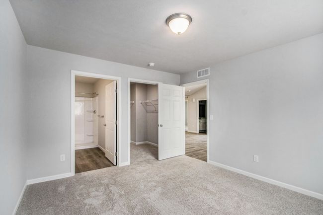 The luxurious primary suite includes a private bath and large walk-in closet. | Image 12