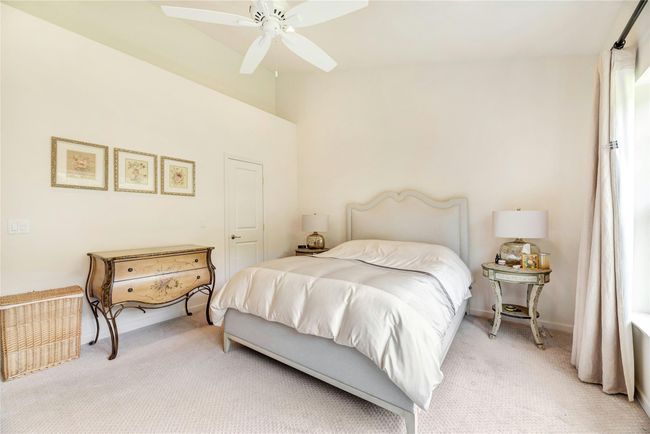 Bedroom with light carpet and ceiling fan | Image 11