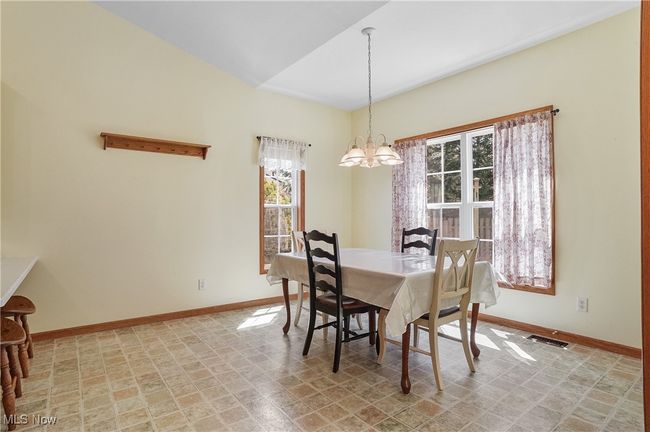 Dining room featuring a chandelier and baseboards | Image 25