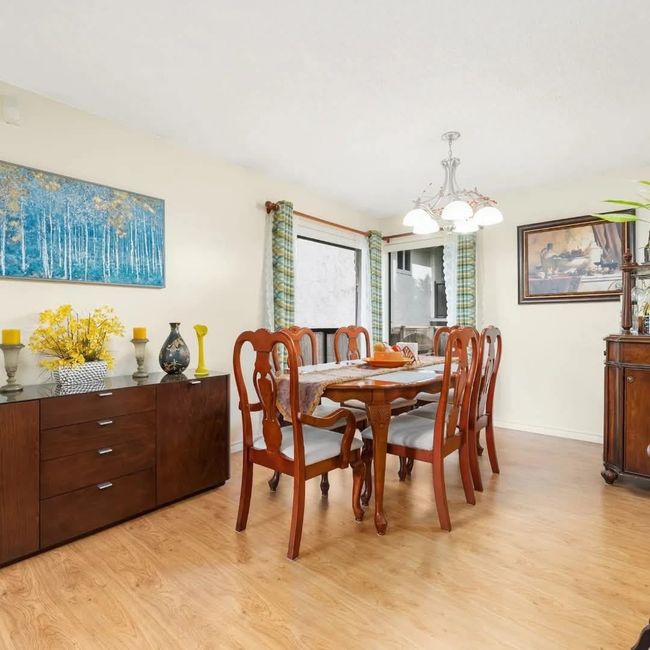 Dining space featuring light wood-style flooring, baseboards, and an inviting chandelier | Image 6