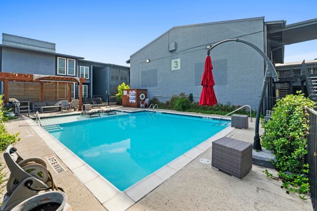Community pool with a patio area, fence, and outdoor lounge area | Image 26