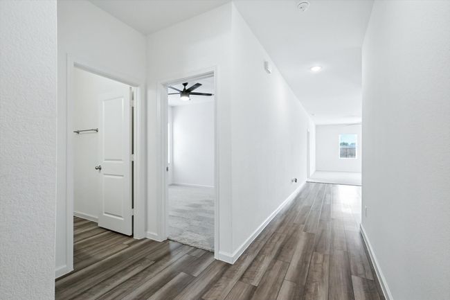 Hall with baseboards and wood finished floors | Image 14