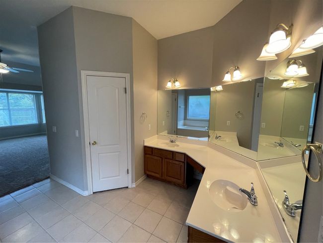 Full bath with tile patterned flooring, double vanity, and ceiling fan | Image 26