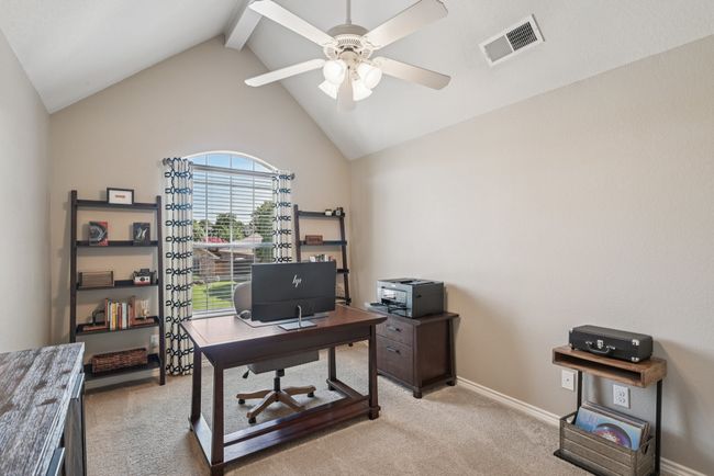 Bedroom being used as an office space featuring light colored carpet and a ceiling fan | Image 27