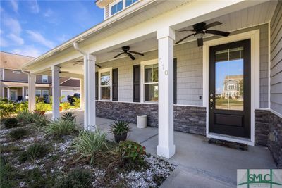 The wide front porch is a perfect spot for some outdoor furniture! | Image 3