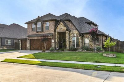 View of front of property with a garage and a front lawn | Image 1