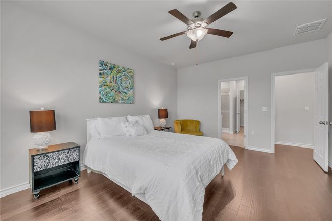 Bedroom with wood finished floors, baseboards, and ceiling fan | Image 9
