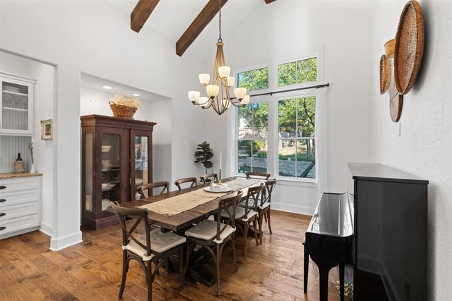 Dining space with beam ceiling, baseboards, high vaulted ceiling, and hardwood / wood-style floors | Image 13