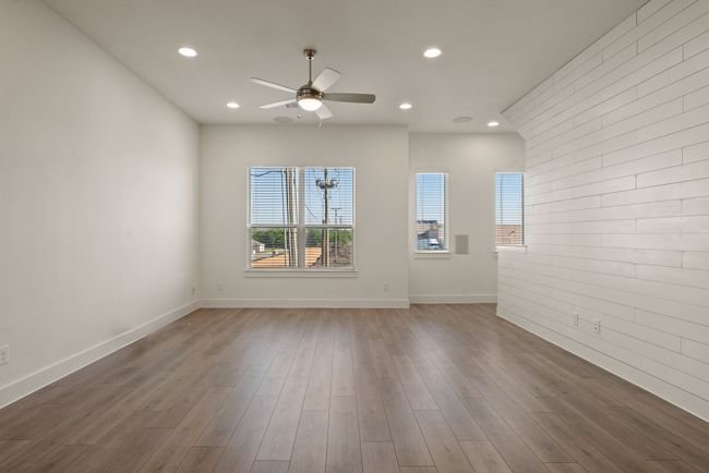 Unfurnished living room with ceiling fan, baseboards, wood finished floors, and recessed lighting | Image 13