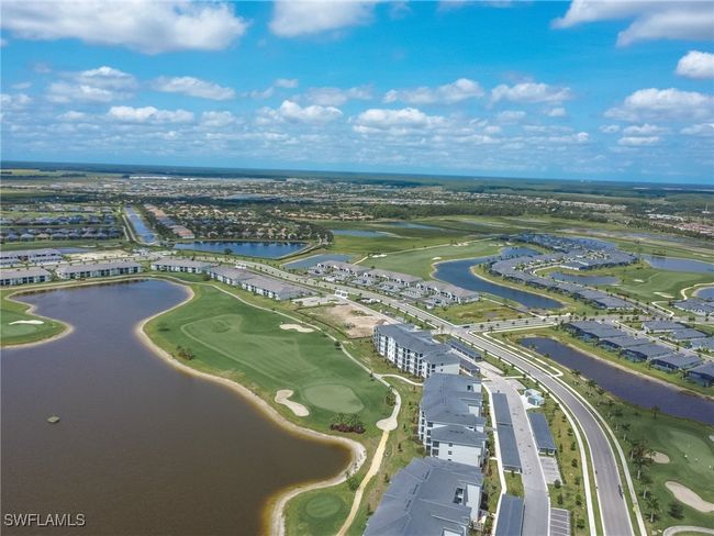 Aerial perspective of suburban area featuring a large body of water and a local golf course | Image 38