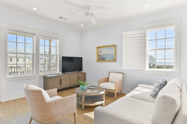 Living room features 10ft ceilings, custom window treatments, and plenty of natural lighting. | Image 7