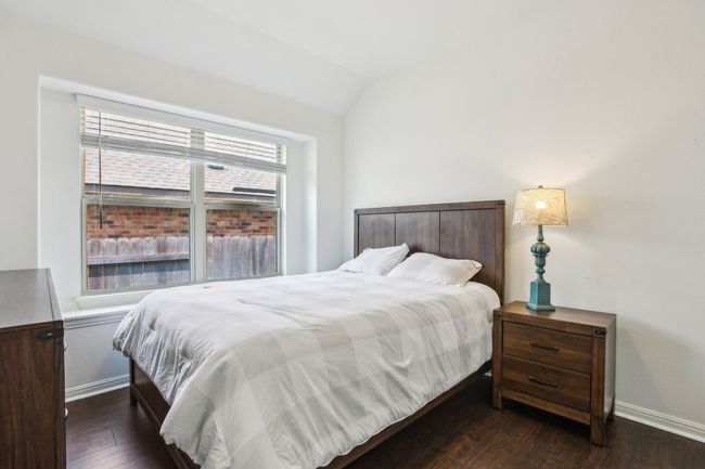 Bedroom featuring vaulted ceiling, baseboards, and wood-type flooring | Image 28