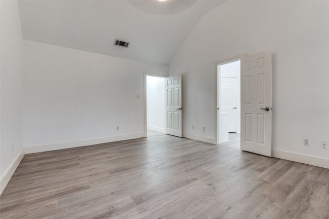 Spare room featuring high vaulted ceiling and light wood finished floors | Image 16