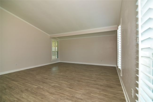 Unfurnished room featuring wood finished floors, baseboards, and ornamental molding | Image 6