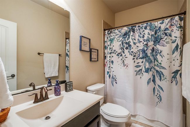 Full bath with shower tub combo is adjacent to first floor bedroom. | Image 20