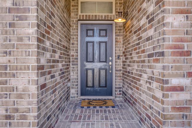 Doorway to property featuring brick siding | Image 6