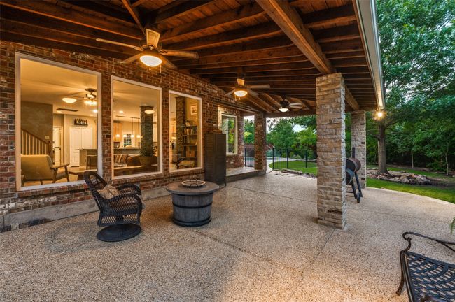 Covered cedar back patio with fire pit, ceiling fans, and fantastic view of trees, trees, trees | Image 4