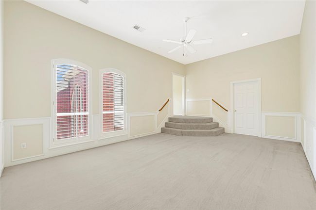 Another view of bright and inviting game room, featuring large windows with elegant shutters. | Image 37