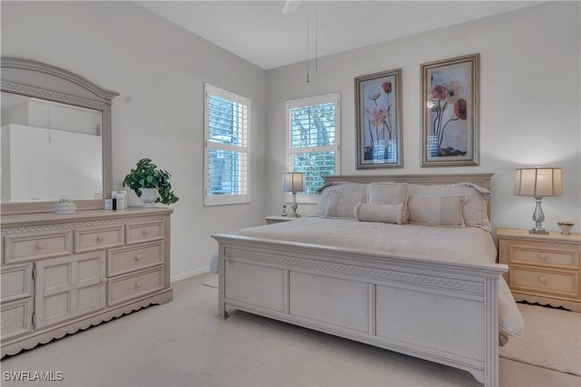 Bedroom featuring light colored carpet and baseboards | Image 16
