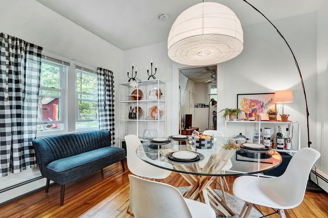 Dining area with a baseboard radiator, wood-type flooring, and ceiling fan | Image 5