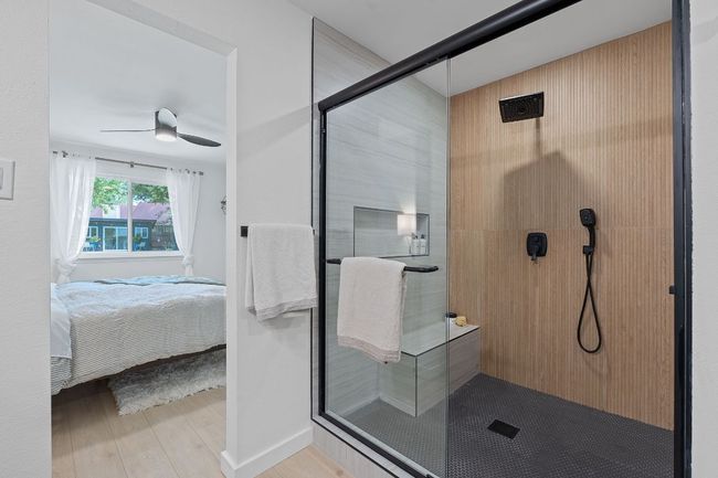 Ensuite bathroom featuring a shower stall and wood finished floors | Image 20