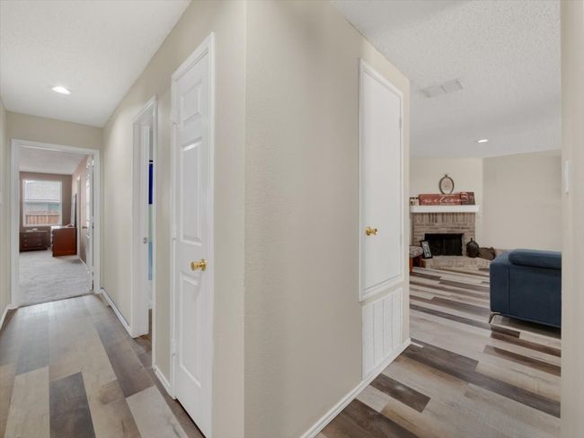 Hall featuring a textured ceiling and light hardwood / wood-style flooring | Image 13