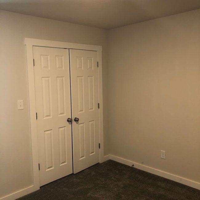 Unfurnished bedroom featuring dark carpet, baseboards, and a closet | Image 13