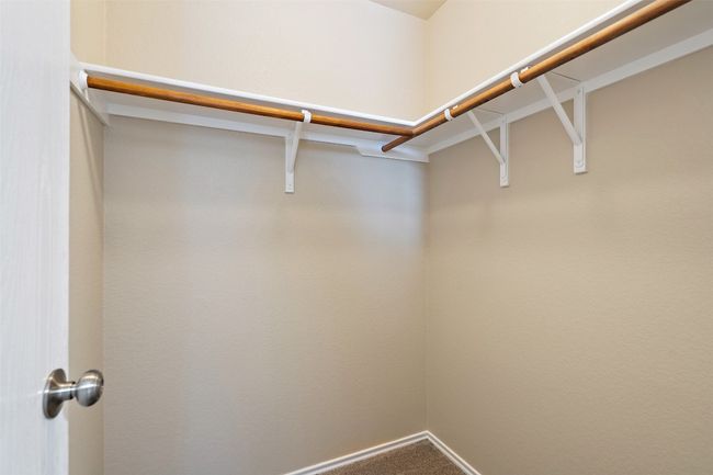 Walk in closet with carpet floors | Image 27
