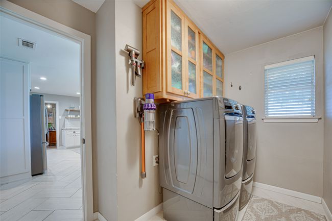Laundry room with washer and clothes dryer and cabinet space | Image 26