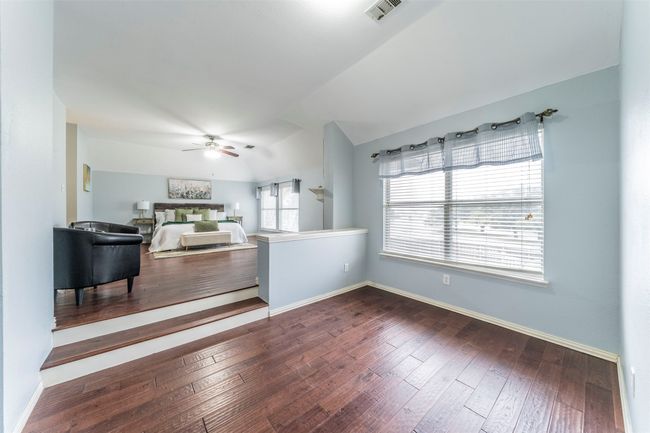 Living area with ceiling fan, vaulted ceiling, and dark wood-style flooring | Image 23