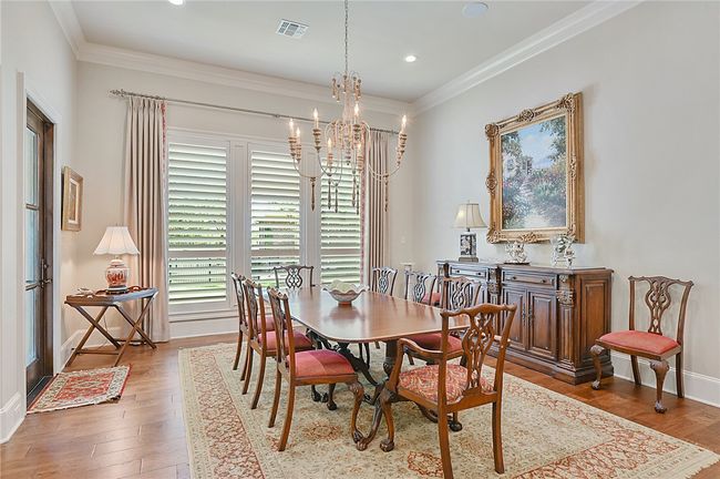 Dining space with a chandelier, wood finished floors, crown molding, recessed lighting, and baseboards | Image 17